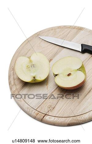 Sliced apple and knife on wooden plate over white background View Large Photo Image Stock Photo - Sliced apple and knife on wooden plate over white background. Fotosearch