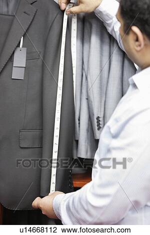 Tailor taking measurement of suit's sleeve View Large Photo Image Stock Image - Tailor taking measurement of suit's sleeve. Fotosearch