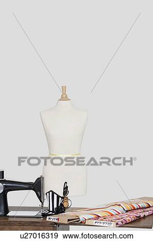 Tailor's dummy with hat and cloth pattern on sewing machine over colored background View Large Photo Image Stock Photo - Tailor's dummy with hat and cloth pattern on sewing machine over colored background. Fotosearch