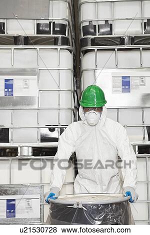 Technician in hazmat suit holding plastic covered chemical drum View Large Photo Image Stock Photo - Technician in hazmat suit holding plastic covered chemical drum. Fotosearch