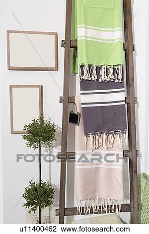 Stock Image - Towels on a wooden ladder at furnishing store. Fotosearch