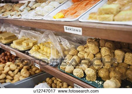 Variety of Indian sweet food displayed at store View Large Photo Image Stock Photo - Variety of Indian sweet food displayed at store. Fotosearch