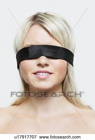 Young blindfolded woman against gray background View Large Photo Image Stock Photo - Young blindfolded woman against gray background. Fotosearch