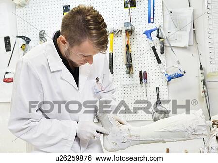 Young male worker working on prosthetic limb in workshop View Large Photo Image Stock Photograph - Young male worker working on prosthetic limb in workshop. Fotosearch