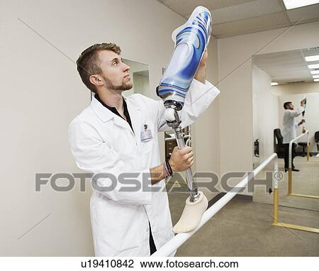 Young technician with advanced prosthetic foot View Large Photo Image Stock Image - Young technician with advanced prosthetic foot. Fotosearch