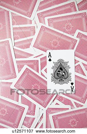 Stock Photo - Ace card on scattered playing cards. Fotosearch