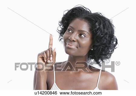 African American young woman pointing her index finger upwards over white background View Large Photo Image Stock Photograph - African American young woman pointing her index finger upwards over white background. Fotosearch
