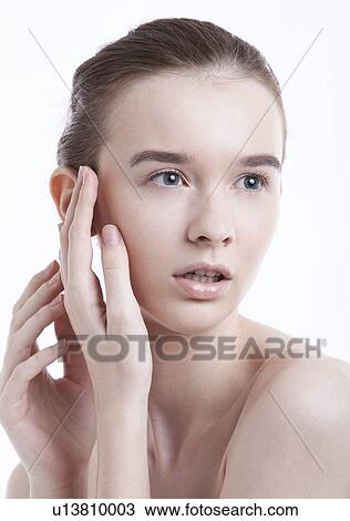 Beautiful young woman looking away against white background View Large Photo Image Stock Image - Beautiful young woman looking away against white background. Fotosearch