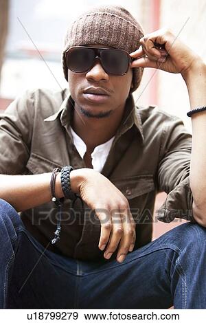 Close-up Portrait of a seated young African American man View Large Photo Image Stock Photo - Close-up Portrait of a seated young African American man. Fotosearch