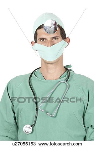Stock Image - Close-up portrait of young surgeon wearing mask, stethoscope, and head mirror. Fotosearch