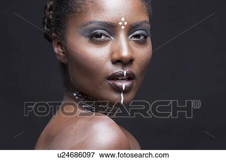 Close-up view of beautiful woman wearing tribal make-up paint View Large Photo Image Stock Photo - Close-up view of beautiful woman wearing tribal make-up paint. Fotosearch