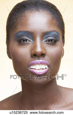 Close-up view of beautiful woman wearing make-up showing her false teeth View Large Photo Image Stock Photography - Close-up view of beautiful woman wearing make-up showing her false teeth. Fotosearch