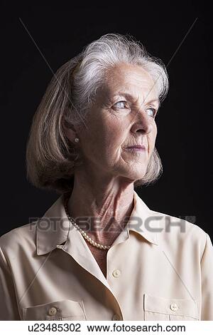 Stock Image - Emotional Portrait of Senior woman reminiscing. Fotosearch