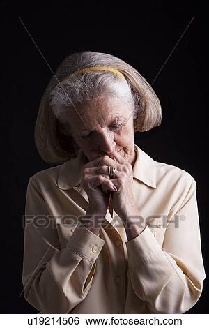 Emotional Portrait of Senior woman praying View Large Photo Image Stock Photograph - Emotional Portrait of Senior woman praying. Fotosearch