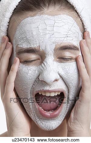 Frustrated young woman with face pack screaming against white background View Large Photo Image Stock Image - Frustrated young woman with face pack screaming against white background. Fotosearch