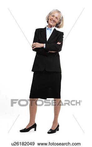 Stock Photo - Full length shot of senior business woman with arms crossed smilling. Fotosearch