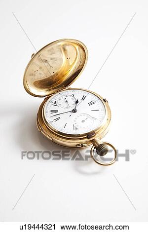 Stock Image - Golden pocket stopwatch over white background. Fotosearch