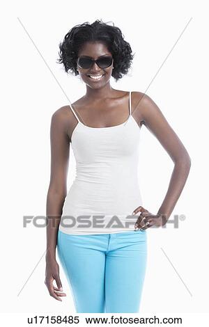 Stock Photography - Happy young African American woman wearing sunglasses standing over white background. Fotosearch