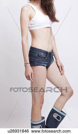 Low section of young woman wearing hotpants and boots against white background View Large Photo Image Stock Photograph - Low section of young woman wearing hotpants and boots against white background. Fotosearch