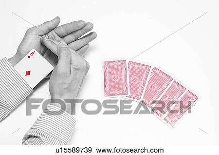 Man's hand hiding ace card with group of playing cards over white background View Large Photo Image Stock Photo - Man's hand hiding ace card with group of playing cards over white background. Fotosearch