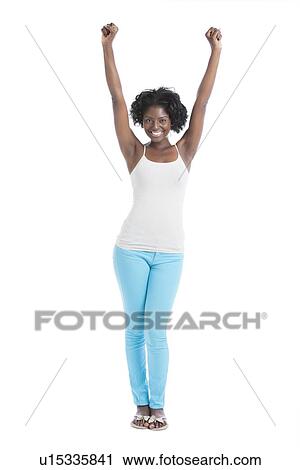 Portrait of a cheerful young woman with arms raised standing over white background View Large Photo Image Stock Image - Portrait of a cheerful young woman with arms raised standing over white background. Fotosearch