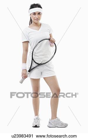 Portrait of a confident young female tennis player standing over white background View Large Photo Image Stock Image - Portrait of a confident young female tennis player standing over white background. Fotosearch