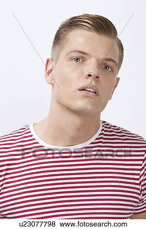 Portrait of a confident young man over white background View Large Photo Image Stock Photo - Portrait of a confident young man over white background. Fotosearch