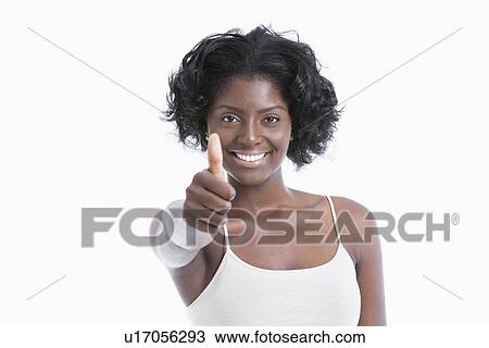 Portrait of a happy young woman gesturing thumbs up over white background View Large Photo Image Stock Image - Portrait of a happy young woman gesturing thumbs up over white background. Fotosearch