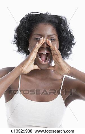Portrait of a playful young woman shouting over white background View Large Photo Image Stock Photo - Portrait of a playful young woman shouting over white background. Fotosearch