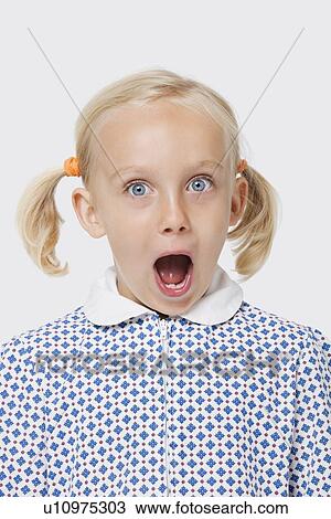 Portrait of a surprised young girl with mouth open over white background View Large Photo Image Stock Image - Portrait of a surprised young girl with mouth open over white background. Fotosearch