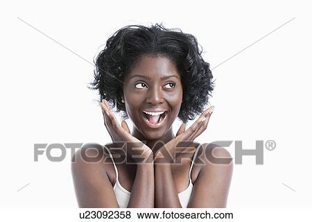 Stock Photo - Portrait of a surprised young woman shouting over white background. Fotosearch