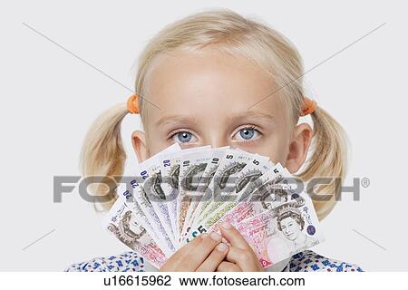 Portrait of a young girl covering mouth with fan of European currencies over white background View Large Photo Image Stock Image - Portrait of a young girl covering mouth with fan of European currencies over white background. Fotosearch