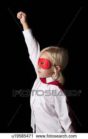 Portrait of a young girl dressed up as a super hero on a black background View Large Photo Image Stock Image - Portrait of a young girl dressed up as a super hero on a black background. Fotosearch