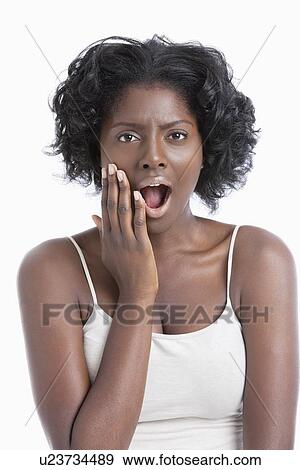 Portrait of an amazed African American young woman over white background View Large Photo Image Stock Photo - Portrait of an amazed African American young woman over white background. Fotosearch