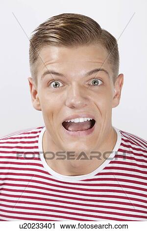 Portrait of an amazed young man over white background View Large Photo Image Stock Image - Portrait of an amazed young man over white background. Fotosearch