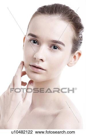 Stock Image - Portrait of beautiful young woman against white background. Fotosearch