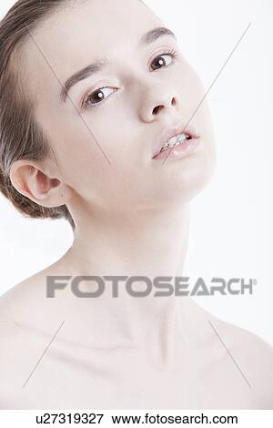 Stock Photo - Portrait of beautiful young woman against white background. Fotosearch