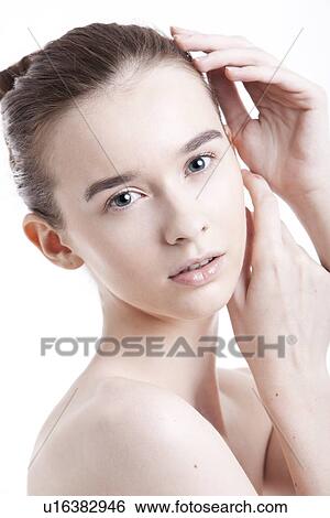 Stock Photograph - Portrait of beautiful young woman against white background. Fotosearch