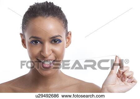 Portrait of beautiful young woman pulling chewing gum from her mouth against white background View Large Photo Image Stock Photograph - Portrait of beautiful young woman pulling chewing gum from her mouth against white background. Fotosearch