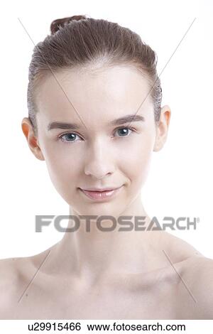 Stock Photograph - Portrait of beautiful young woman smiling against white background. Fotosearch