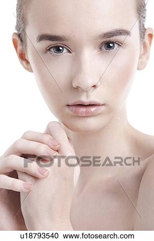 Portrait of beautiful young woman with hands clasped against white background View Large Photo Image Stock Image - Portrait of beautiful young woman with hands clasped against white background. Fotosearch