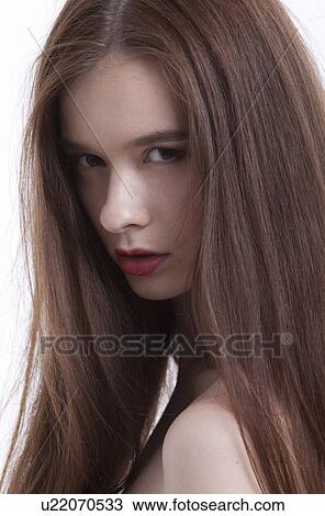 Portrait of beautiful young woman with long hair against white background View Large Photo Image Stock Image - Portrait of beautiful young woman with long hair against white background. Fotosearch