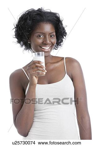 Portrait of happy young woman holding a glass of milk over white background View Large Photo Image Picture - Portrait of happy young woman holding a glass of milk over white background. Fotosearch