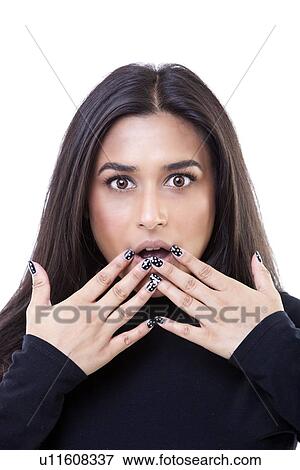 Stock Photo - Portrait of shocked young woman against white background. Fotosearch