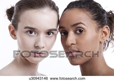 Portrait of two young women against white background View Large Photo Image Stock Photograph - Portrait of two young women against white background. Fotosearch
