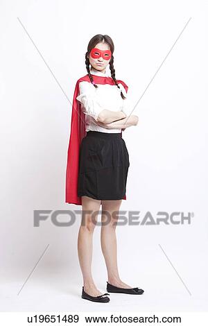 Stock Photo - Portrait of young Asian woman wearing superhero costume against white background. Fotosearch
