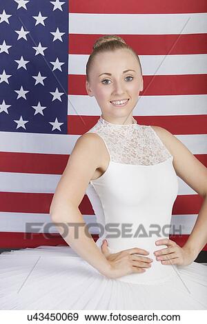 Portrait of young ballet dancer standing against American flag View Large Photo Image Stock Photo - Portrait of young ballet dancer standing against American flag. Fotosearch