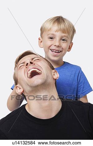 Portrait of young boy playing with father over white background View Large Photo Image Picture - Portrait of young boy playing with father over white background. Fotosearch