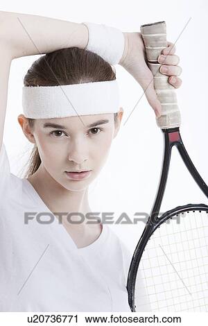 Portrait of young Caucasian woman with tennis racket against white background View Large Photo Image Stock Image - Portrait of young Caucasian woman with tennis racket against white background. Fotosearch