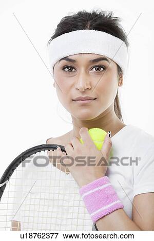 Stock Photo - Portrait of young female tennis player against white background. Fotosearch